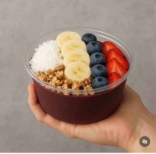 Acai bowl with banana, strawberries, blueberries, granola, and coconut