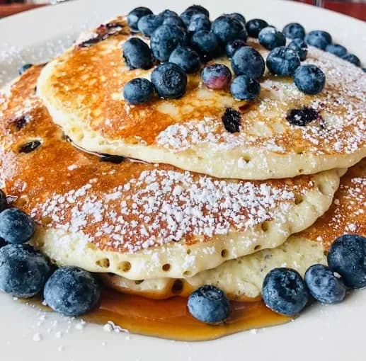 Protein pancakes topped with blueberries and powdered sugar